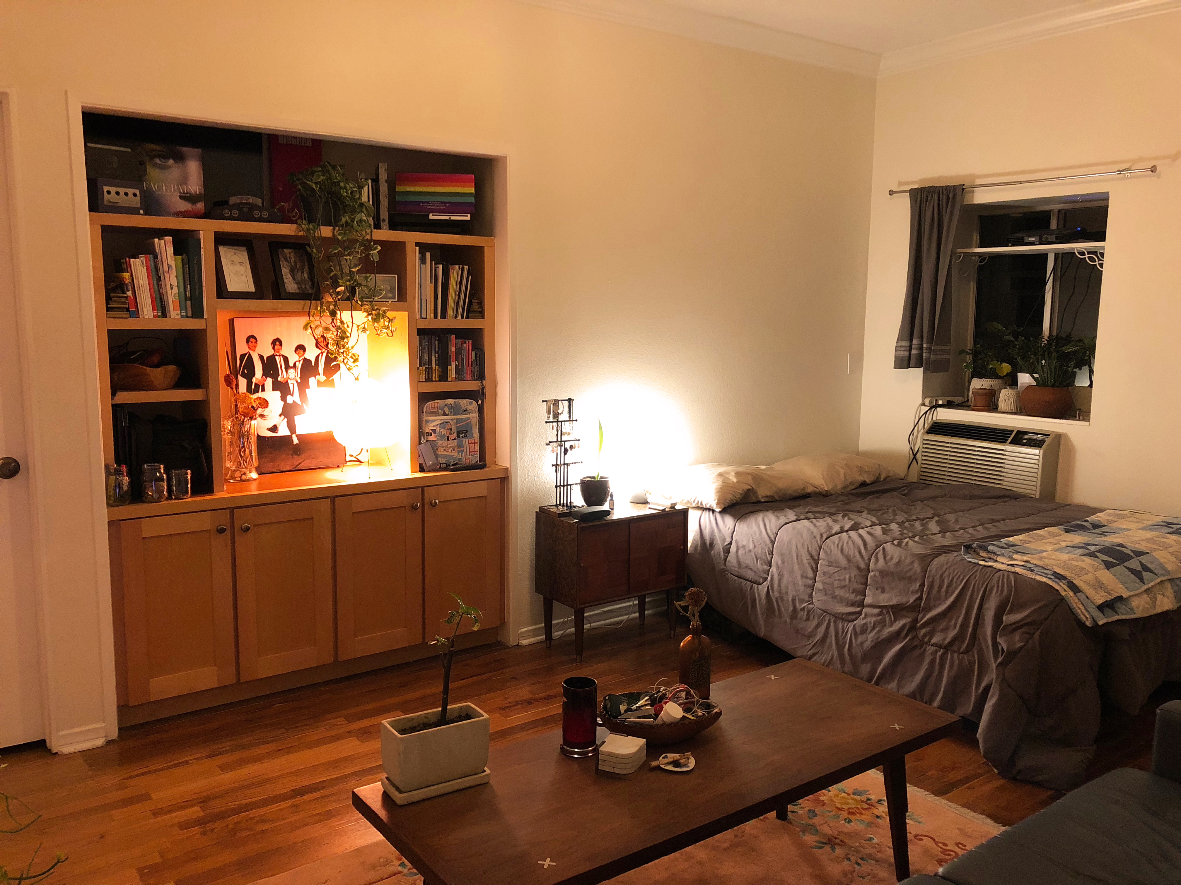A bedroom and entertainment console in warm lighting